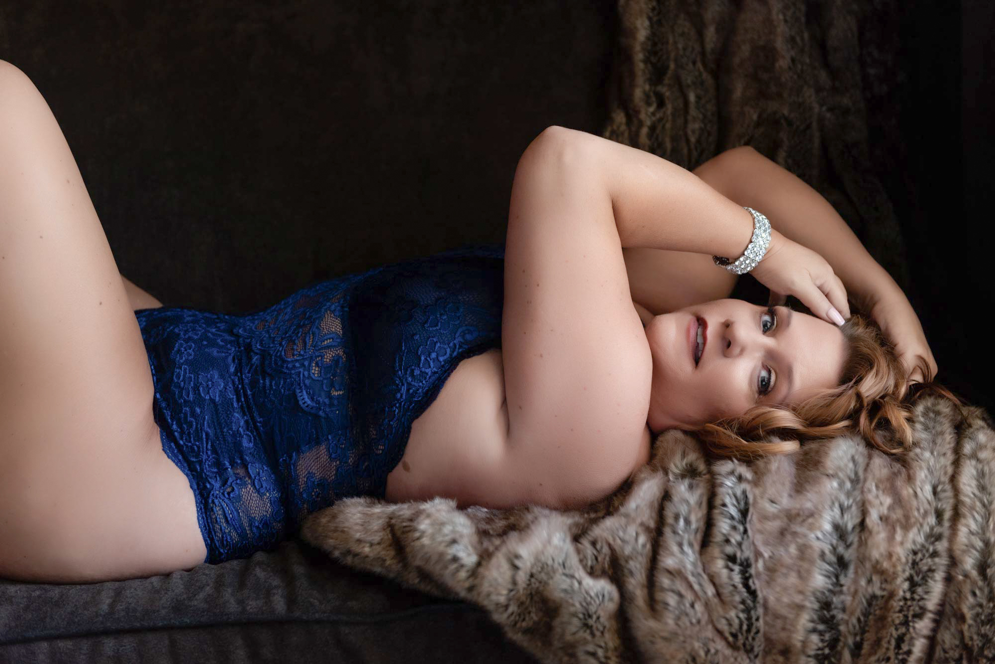 Retouched Boudoir photo of a woman in blue lingerie on a couch