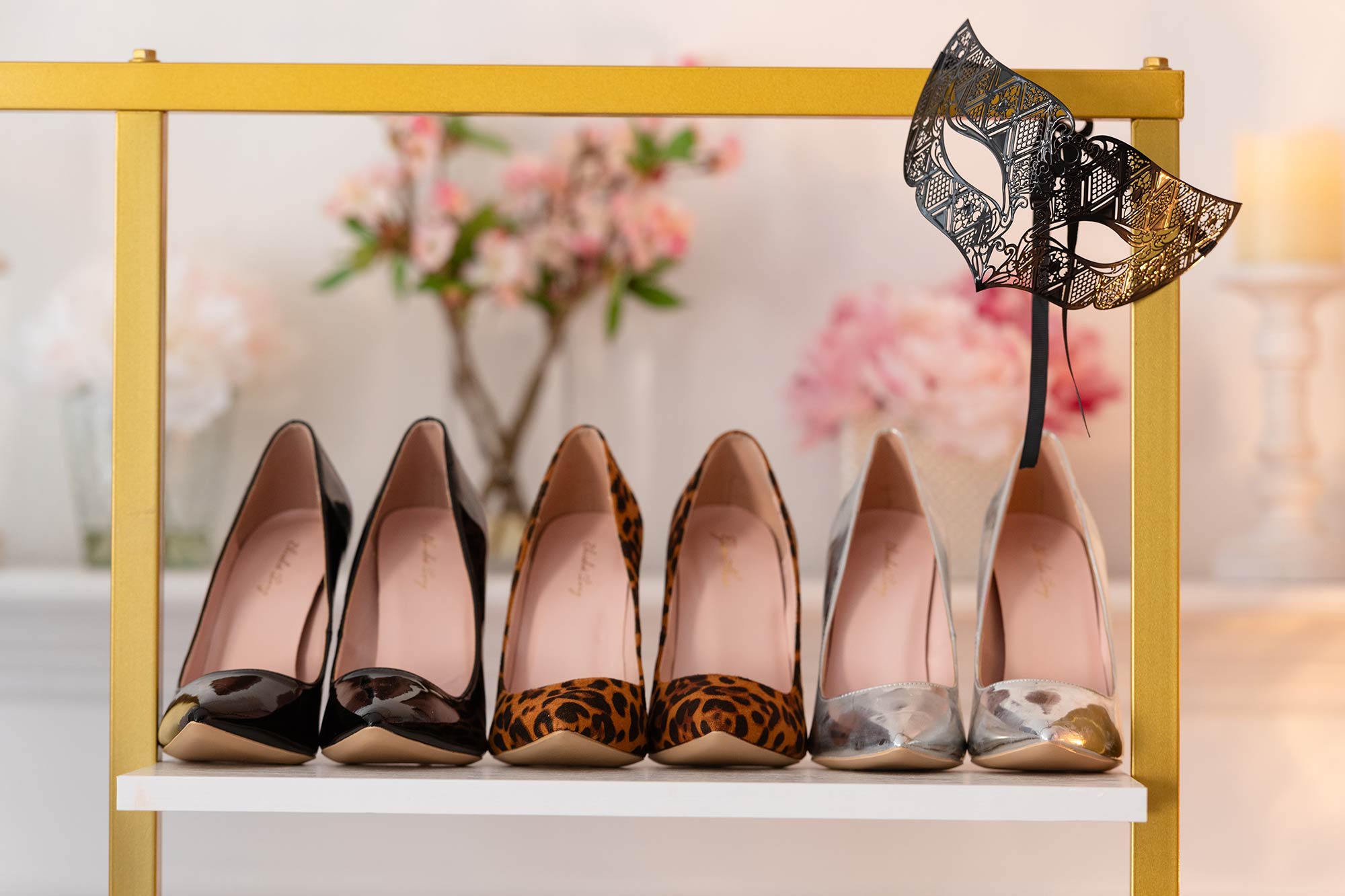 shelve with three pairs of high heeled shoes