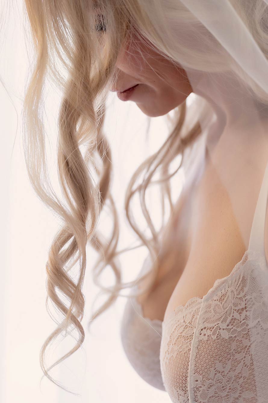 bride looks down as her hair falls forward over her face