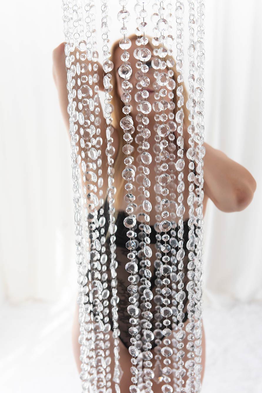 woman can be seen behind a crystal curtain